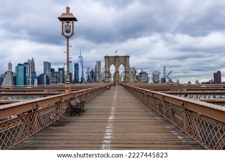 Brooklyn bridge with the rainy clouds in New York City. Royalty-Free Stock Photo #2227445823