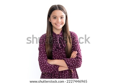 Confident child keep arms crossed, isolated on white background, empty space. Little caucasian teenage girl 12, 13, 14 years old hold hands crossed. Portrait of happy smiling teenage child girl. Royalty-Free Stock Photo #2227446965