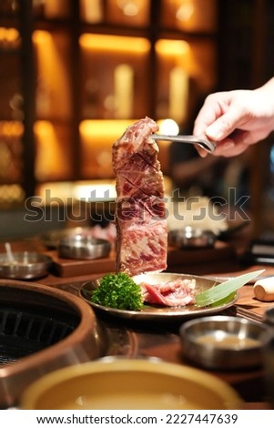 Japanese barbecue, Barbecue grill burning , Japanese buffet restaurant. snowflakes and beef