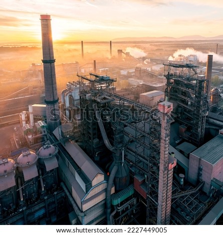 Smelter with blast furnaces from above during autumn foggy morning. Heavy industry plant during sunrise.