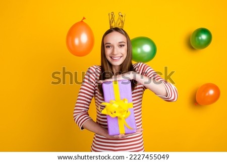 Happy woman in crown with gifts air balloons flying around brithday party isolated on bright shine color background.