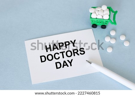 Doctor's Day concept. Medical apparatus such as stethoscope and spiral notepad with Happy Doctors' Day text on it. Flat lay view.