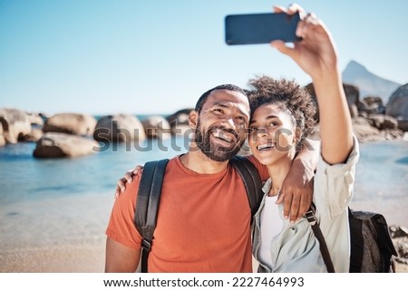 Couple, love and phone selfie on beach for travel adventure or summer vacation. Happy man, woman smile and photography for holiday lifestyle on 5g smartphone for social media at ocean water outdoors