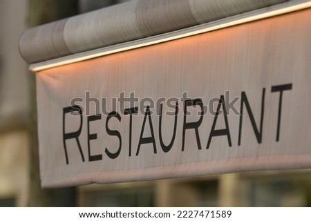 Restaurant sign on the street of Paris.