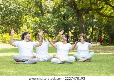 Group of happy mature indian  people wearing white outfit laughing relaxing doing yoga together outdoor at summer park.  Retirement life. Mental health and fitness, Stress free,  Fun activity.  Royalty-Free Stock Photo #2227478193