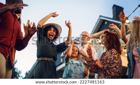 Diverse Multicultural Friends and Family Dancing Together at an Outdoors Garden Party Celebration. Young and Senior People Having Fun on a Perfect Summer Afternoon. Slow Motion Footage.
