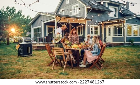 Big Family Garden Barbecue Party Celebration, Gathered Together at a Table with Relatives and Friends. Young and Senior People are Eating, Drinking, Passing Dishes, Joking and Having Fun. Royalty-Free Stock Photo #2227481267