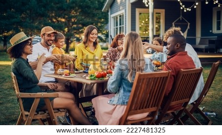 Parents, Children, Relatives and Friends Having an Open Air Vegetarian Dinner in Their Backyard. Old and Young People Talk, Chat, Have Fun, Eat and Drink. Garden Party Celebration in a Backyard. Royalty-Free Stock Photo #2227481325