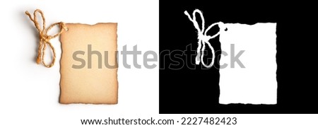 Old cardboard label with worn edges and a rope tied in the shape of a bow isolated on white background with clipping path or alpha channel Royalty-Free Stock Photo #2227482423