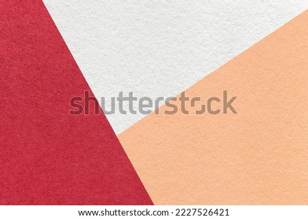 Texture of craft white, red and coral shade color paper background, macro. Structure of vintage wine abstract cardboard with geometric shape and gradient. Felt backdrop closeup.