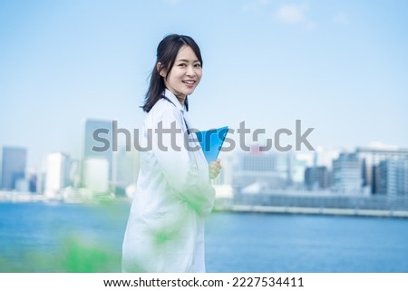 Researcher woman walking outside with a smile