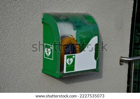 First aid AED defibrillator wall mounted storage cabinet in metal plastic transpa comes key door handle, fits all brands cardiac science for public place, plastic box, public park, street, restaurant  Royalty-Free Stock Photo #2227535073