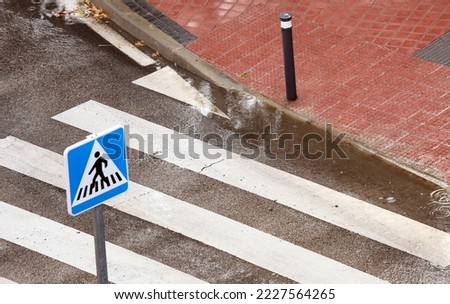 Pedestrian crossing in rainy day