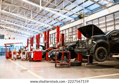 car in automobile repair service center with soft-focus and over light in the background Royalty-Free Stock Photo #2227567159