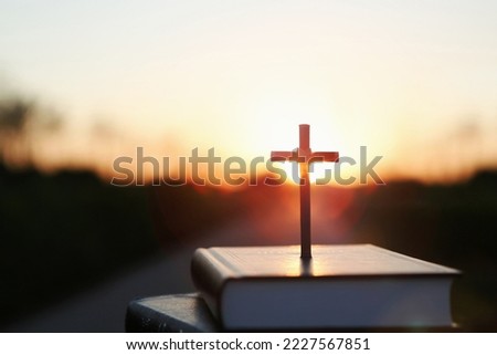 Bright sun light and bible book and the cross silhouette of the Holy Jesus Christ guiding the bright path
 Royalty-Free Stock Photo #2227567851
