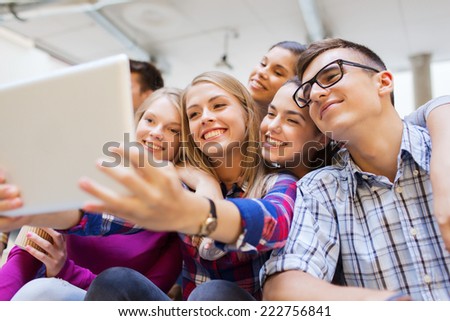 education, high school, technology and people concept - group of smiling students with tablet pc computer taking photo or video indoors
