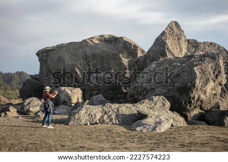 Moonstone beach, California, September 15, 2022: Moonstone Beach in Northern California Looking at a mature beautiful Woman taking Pictures