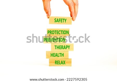 Health and safety symbol. Concept words Safety Protection Prevention Therapy Health Relax on wooden blocks on a beautiful white table white background. Businessman hand. Health and safety concept.
