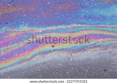 Gasoline spilled on the pavement. Space background picture. Mood.