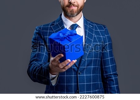 selective focus of businessman with present isolated on red background. businessman