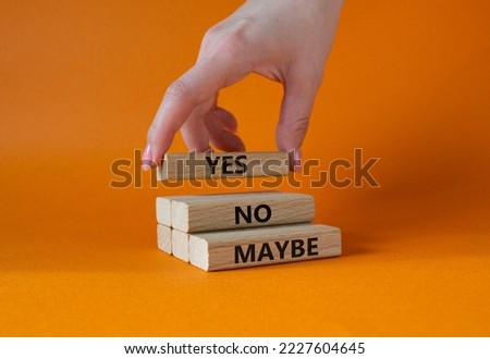Yes No Maybe symbol. Concept word Yes No Maybe on wooden blocks. Beautiful orange background. Businessman hand. Business and Yes No Maybe concept. Copy space. Royalty-Free Stock Photo #2227604645