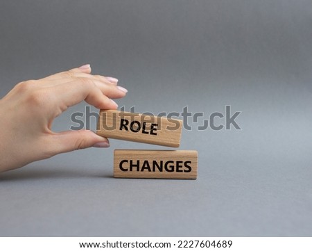 Role changes symbol. Concept words Role changes on wooden blocks. Beautiful grey background. Businessman hand. Business and Role changes concept. Copy space.