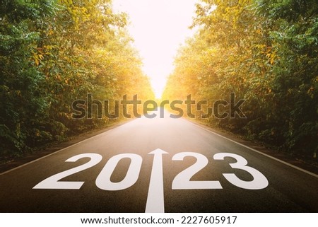The new year 2023 or straightforward concept. Text 2023written on the road in the middle of asphalt road at sunset. planning and challenge, business strategy, opportunity, hope, and new life.
 Royalty-Free Stock Photo #2227605917