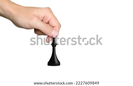 Human hand with wooden chess piece