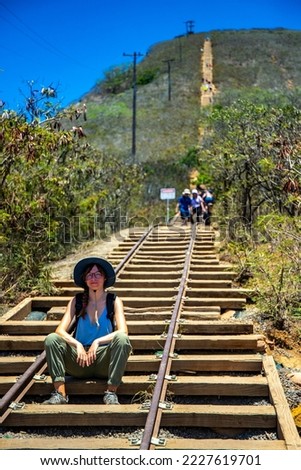 backpacker girl in hat hiking on steps of famous koko crater railway trailhead, oahu, hawaii, hiking in hawaii, holiday in hawaii