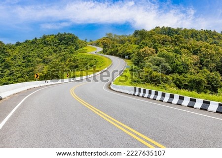 Popular view point of double s-curve road up to the hill with green tree and sky, called curve number 3 at Nan province, Northern of Thailand