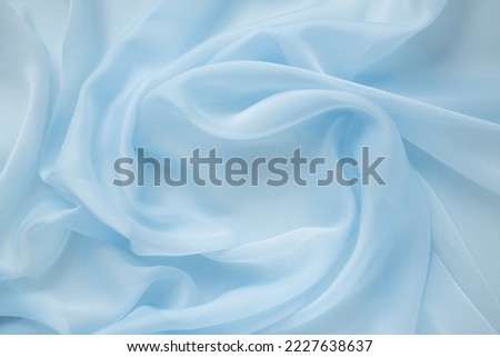 Texture chiffon fabric in blue color for backgrounds. silk fabric. selective focus Royalty-Free Stock Photo #2227638637