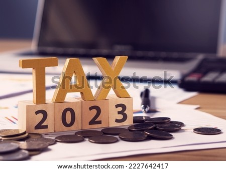 Tax wooden letter and 2023 number on wooden block.Pay tax in 2023 years. The new year 2023 tax concept.Income tax return. Royalty-Free Stock Photo #2227642417