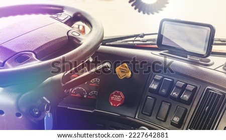 Interior of modern semi truck interior cabin with electronic log boog screen on dashboard. Trucking business with details of dashboard . Hours of Service compliance  Royalty-Free Stock Photo #2227642881