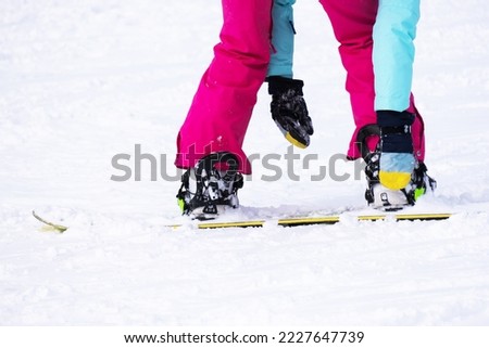 Foot of a skier wearing ski boots. High quality photo
