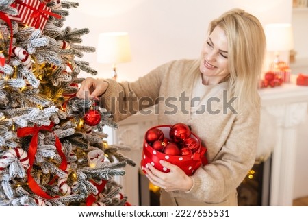 blonde stylish woman decorating christmas tree