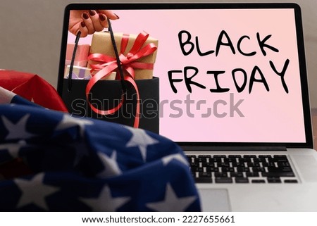 black friday on laptop next to american flag