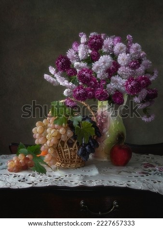 Still life with bouquet of chrysanthemums and grapes