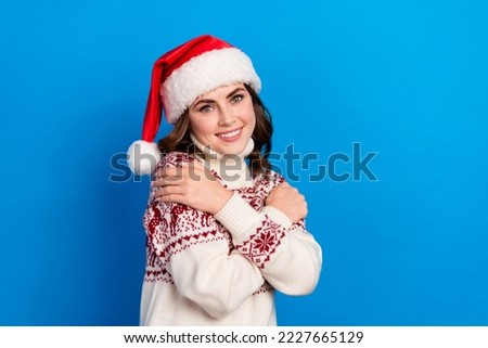 Photo of cute joyful lady wear stylish ugly cozy pullover hug herself like quality clothes isolated on blue color background