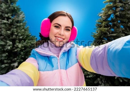 Photo of pretty cheerful positive lady make picture video record enjoy nice weather walking snowy park shine frosty day fresh air outside