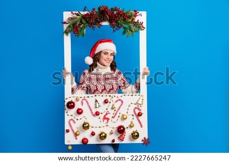 Photo of positive cute lady wear stylish jumper hold retro shot social media cadre new year decoration isolated on blue color background