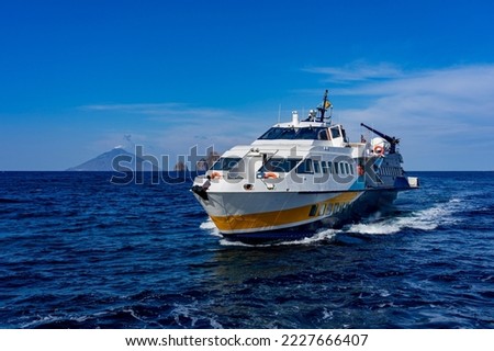 Fast ferry in the Aeolian Islands: hydrofoil, hydrofoil close to the Lipari coast Royalty-Free Stock Photo #2227666407