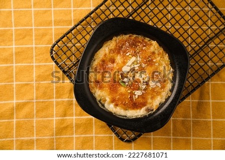 Um Ali, which means the Mother of Ali. It is a traditional oriental dessert that contains bread, milk  Royalty-Free Stock Photo #2227681071