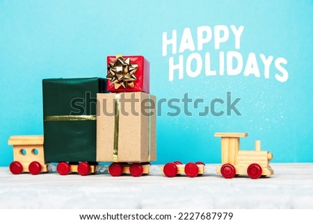 wooden children's train carries presents gifts under the Christmas tree postcard	

