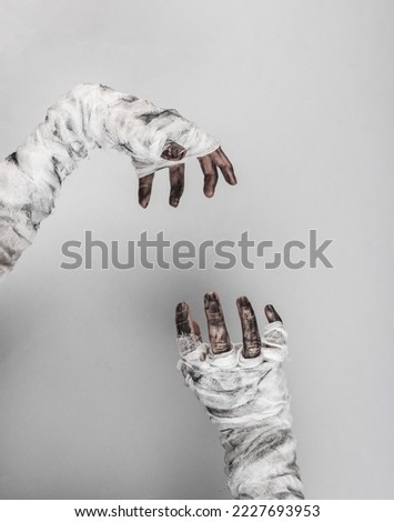 Mummy hands wrapped in a bandage isolated on a black background. Halloween concept