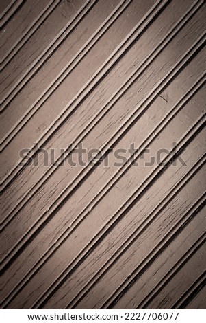 A brown painted wooden background, thin boards in diagonal position. vignetted. vertical image for social media backgrounds.