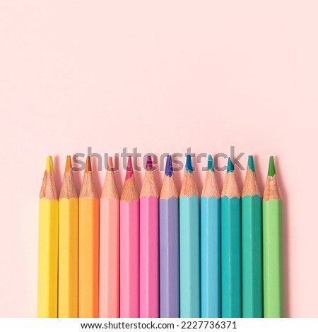 Pastel color pencils on pink background Royalty-Free Stock Photo #2227736371