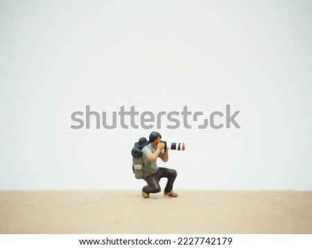 Miniature toy at table with white background.