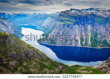 Trolltunga or Troll Tongue is a rock formation  at the Hardangerfjord near Odda town in Hordaland, Norway Royalty-Free Stock Photo #2227750477