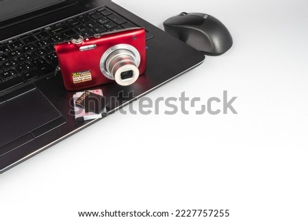 Laptop with wireless mouse, red digital camera and memory SD card - EDC everyday carry - empty space - white background