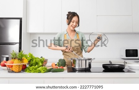 Portrait of a housewife in the kitchen at home Royalty-Free Stock Photo #2227771095